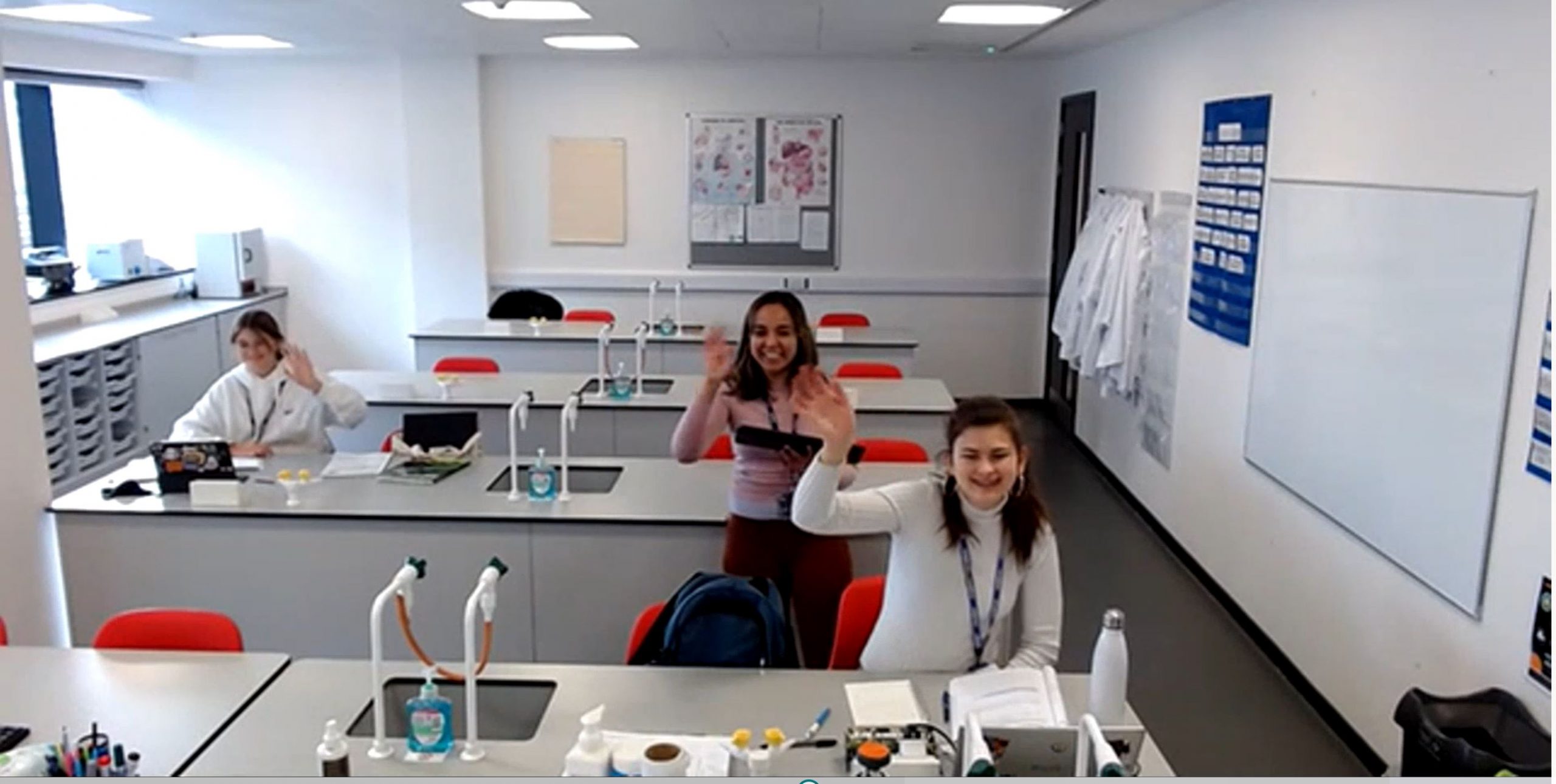students waving in the lab room