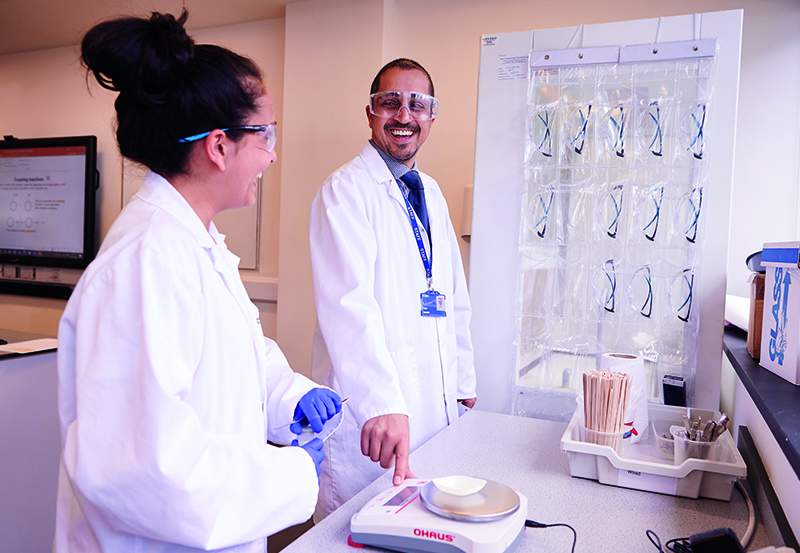 Female Student And Teacher In Science Class At DLD College London