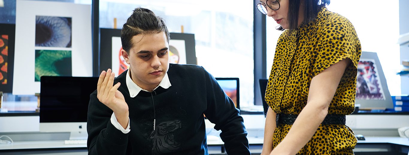 Male student and teacher working in Art class at DLD College London