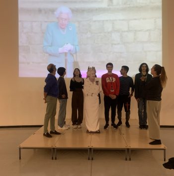 pupils standing with a model of the queen