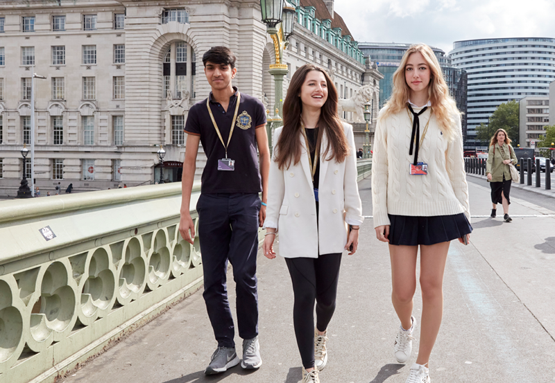 DLD Students Walking Across Westminster Bridge In London With DLD College London In The Background